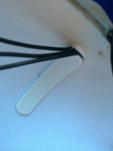 The wires passing inside the hat. The big plastic thing is the backside of the ear mounts.