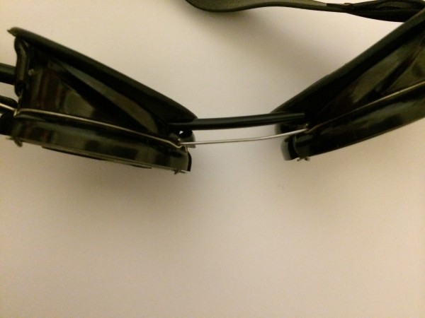 Behind the metal wire connecting the two goggle halves is a segment of heat shrink tubing acting as a channel for wires.